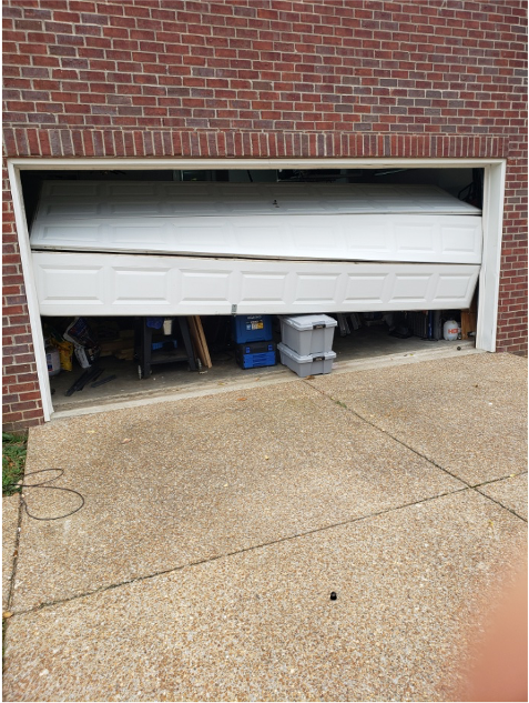 Half-open white garage door on a brick house, serviced by Brentwood Garage Door Services.