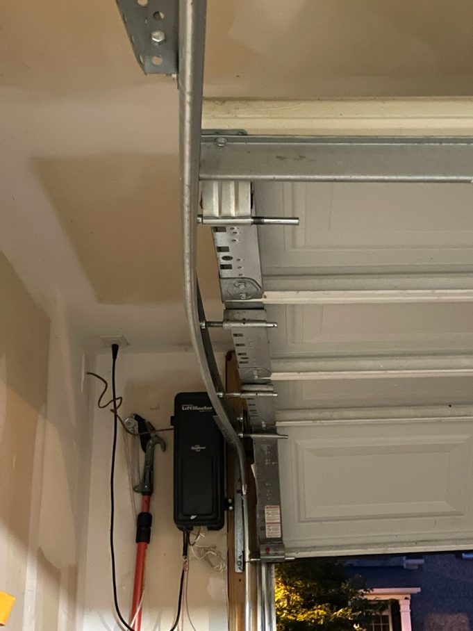 Garage door track and opener system serviced by Brentwood Garage Door Services.