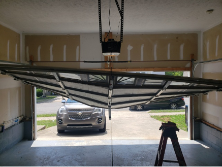 Open garage door with a car outside, serviced by Brentwood Garage Door Services.