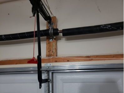 Skilled technician adjusts garage door mechanism, ensuring Brentwood’s finest repair service.