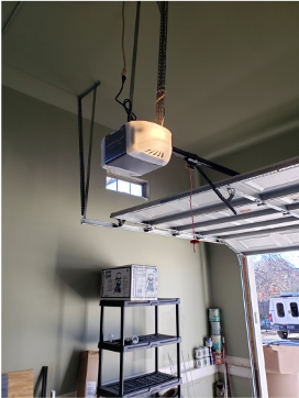 Garage door opener system in a clean garage, installed by Brentwood Garage Door Services.